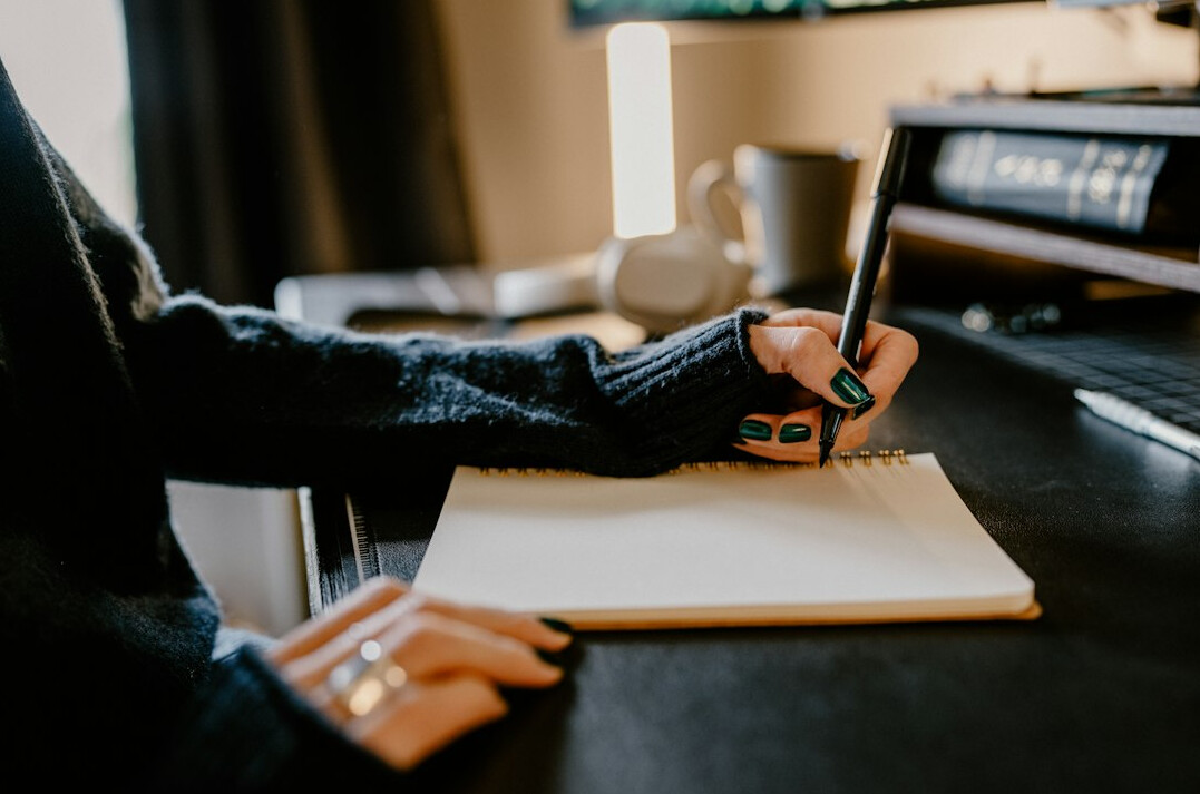 writer at desk with notebook